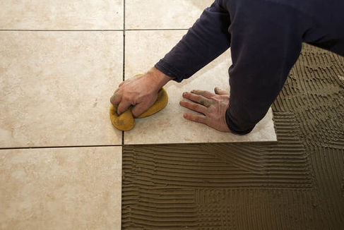 Professional from Hershey Handyman in Hershey, PA, installing tile flooring